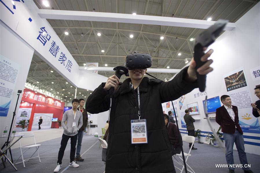 Visitors view a robot at the 13th Optics Valley of China International Optoelectronic Exposition and Forum in Wuhan, capital of central China's Hubei Province, Nov. 3, 2016.