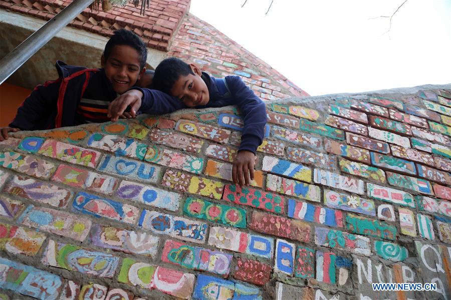 Children play at lady Didi's Nile River School in Ayyat district on the outskirts of Giza Province, about 100 km south of Cairo, capital of Egypt, on March 26, 2017. Diana Sandor, known as Didi, an old Hungarian-born German-raised woman, covered the long distance from West to East six years ago to open her Nile River School as a charitable kindergarten and educational center at the heart of remote, impoverished Baharwa village of Ayyat district on the outskirts of Giza Province, about 100 km south of the Egyptian capital Cairo. Didi said she started building the center 'brick by brick,' through little donations from friends and volunteers around the world and that she is concerned with 'teaching children life,' not just languages and skills. (Xinhua/Ahmed Gomaa) 