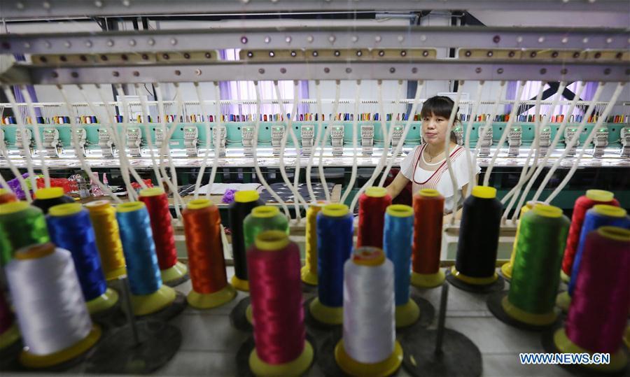 A staff member works on the production line at a toy company in Wuzhi County, central China\'s Henan Province, Aug. 11, 2018. China\'s efforts and success in poverty reduction can help other developing nations, said experts observing the country\'s ongoing Two Sessions. The Two Sessions refer to the annual gatherings of the National People\'s Congress (NPC) and the National Committee of the Chinese People\'s Political Consultative Conference, China\'s top legislature and political advisory body respectively. China has emerged as a global role model with efforts in structural transformation and industrial upgrading, lifting hundreds of millions of people out of poverty, said retired Lieutenant Colonel Muhammad Faruk Khan, a presidium member of Bangladesh\'s ruling Awami League. (Xinhua)