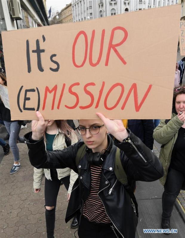 A woman holds a placard in a march against climate change in Zagreb, Croatia, March 15, 2019. (Xinhua/Marko Lukunic)